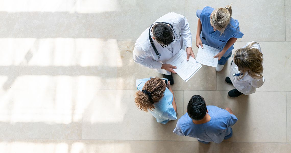 Overhead perspective of a group of doctors standing in a circle