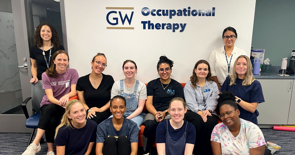 SLP and OT group in front of GW OT sign