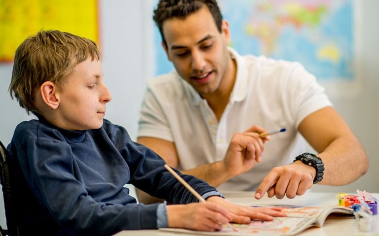 Male Occupational Therapist Assisting Client