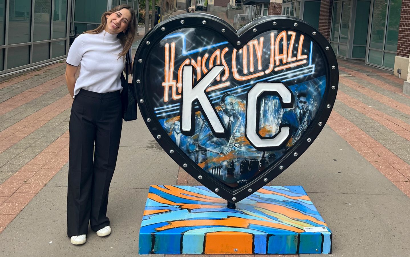 OT Student smiling next to Kansas City Jazz heart sign