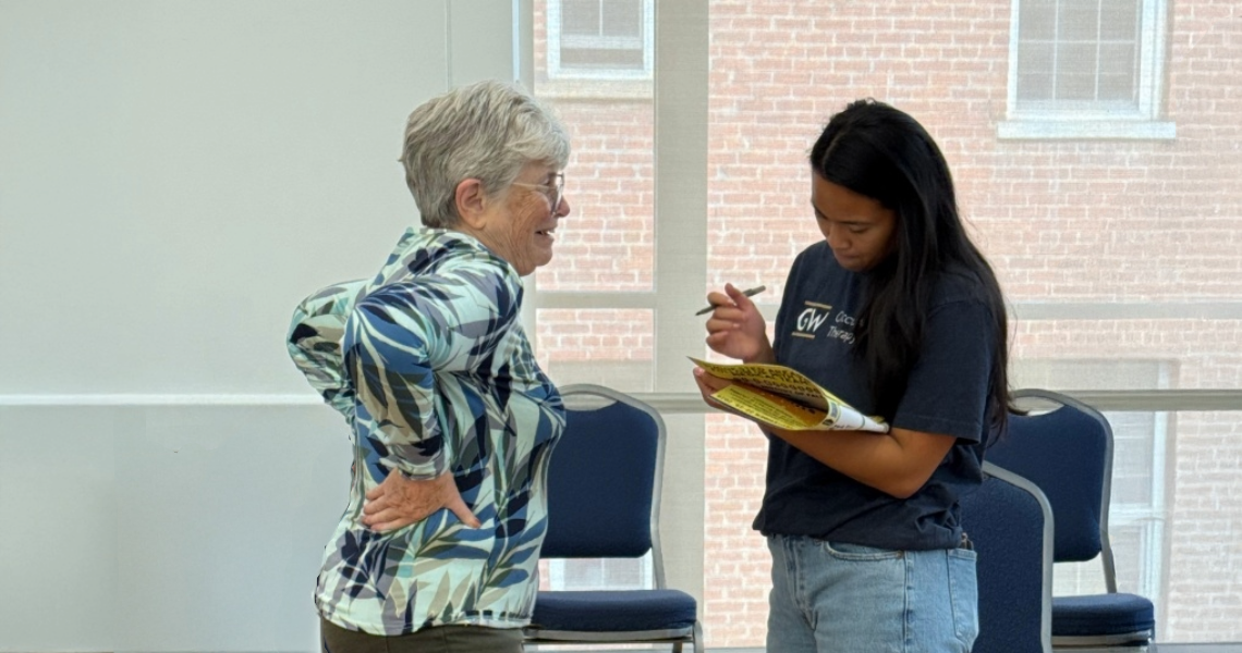 OT student Nicole Tran writing notes at Falls Prevention Awareness Day