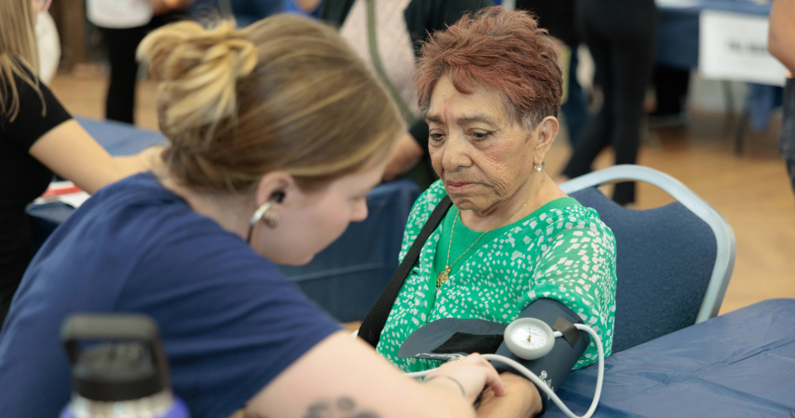 Student at Falls Prevention Awareness Day checking blood pressure
