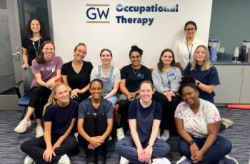 SLP and OT group in front of GW OT sign