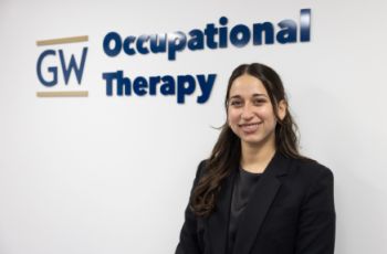 Natalia Anzaldúa Ayala in front of GW OT sign