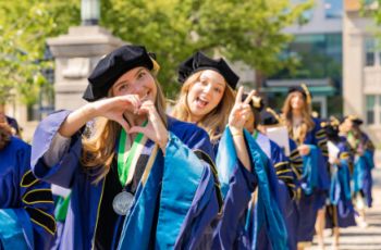 Molly Dougherty and Amy Eybers in line for graduation